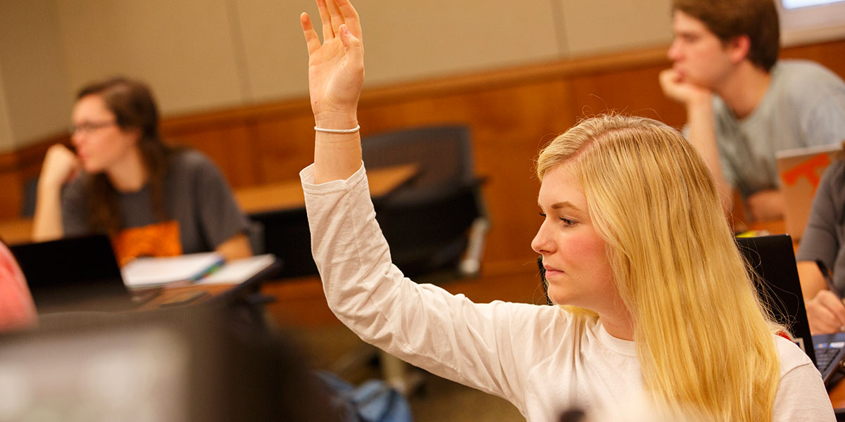 Student raising her hand in the classroom